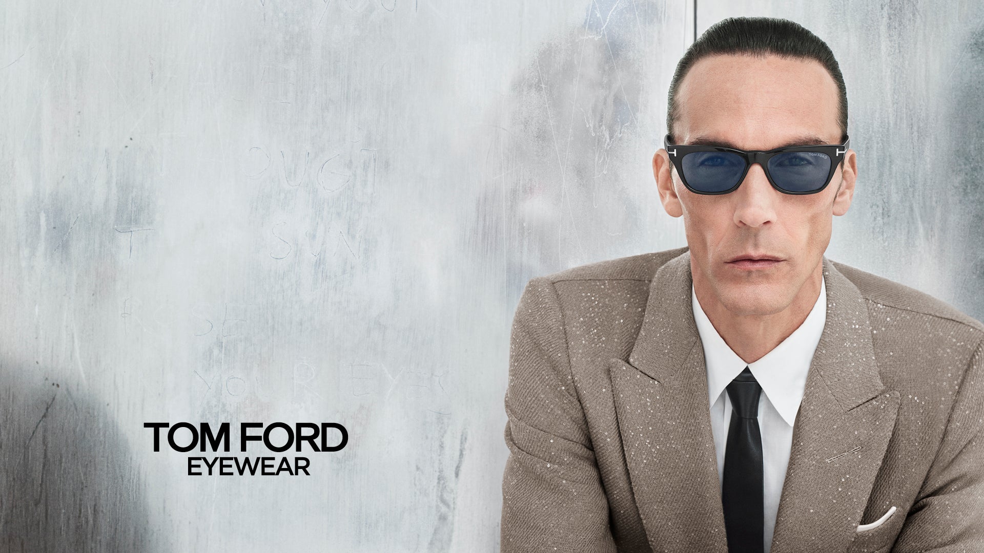 Close-up of a man wearing Tom Ford sunglasses, Fall/Winter 2025 collection. Elegant and sophisticated style for the colder season.