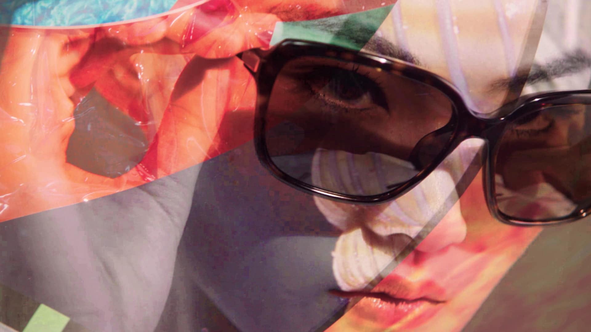 Abstract close-up of a woman wearing elegant tortoiseshell Prada sunglasses. The image is overlaid with colored geometric shapes, referencing the Christmas season. Promotional banner: Prada Eyewear 50% off.